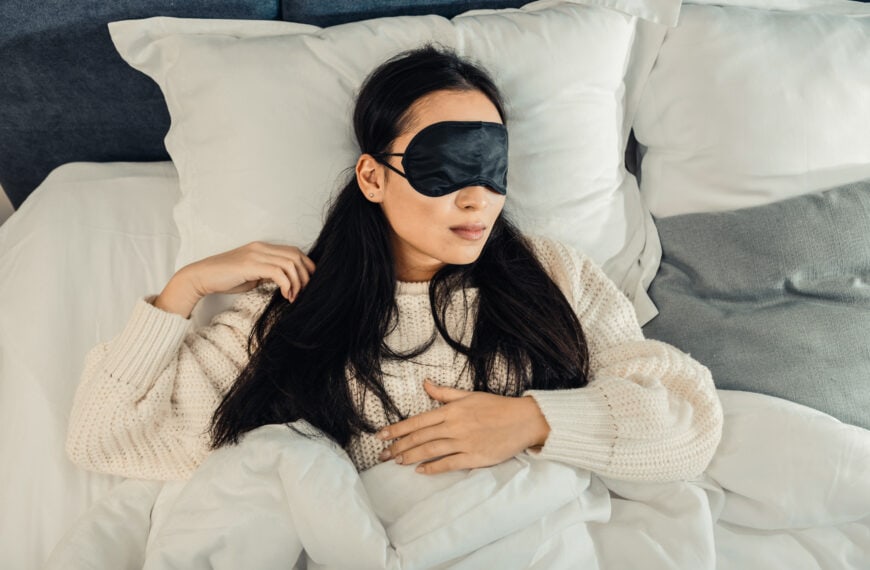 Young woman sleeping alone in her bed